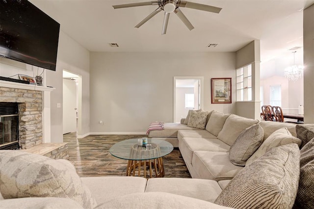 2732 SE 90th St, Moore, OK 73160 - living area with a ceiling fan, wood finished floors, a chandelier, and a stone fireplace