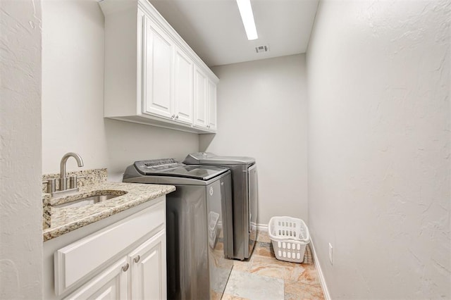 2732 SE 90th St, Moore, OK 73160 - washroom with washer and dryer, cabinet space, and light stone finish flooring