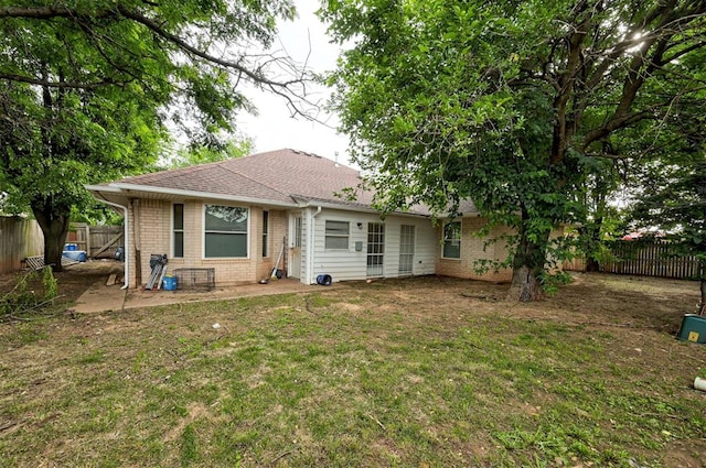 2732 SE 90th St, Moore, OK 73160 - back of property featuring brick siding, a fenced backyard, and roof with shingles