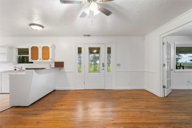 39525 W 151st St, Bristow, OK 74010 - entryway with wood finished floors, ceiling fan, a textured ceiling, and ornamental molding