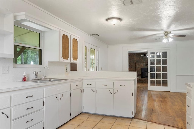39525 W 151st St, Bristow, OK 74010 - kitchen featuring ceiling fan, light countertops, white cabinetry, and a peninsula
