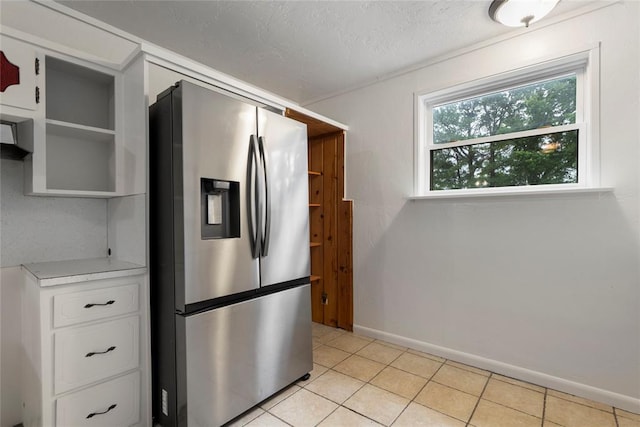 39525 W 151st St, Bristow, OK 74010 - kitchen with stainless steel refrigerator with ice dispenser, open shelves, light countertops, light tile patterned floors, and a textured ceiling