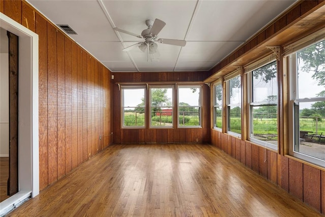 39525 W 151st St, Bristow, OK 74010 - unfurnished sunroom featuring wooden walls, wood finished floors, and plenty of natural light