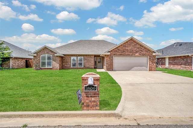 1809 Foxtail Cir, Altus, OK 73521 - view of front of home with an attached garage, concrete driveway, a front yard, brick siding, and roof with shingles