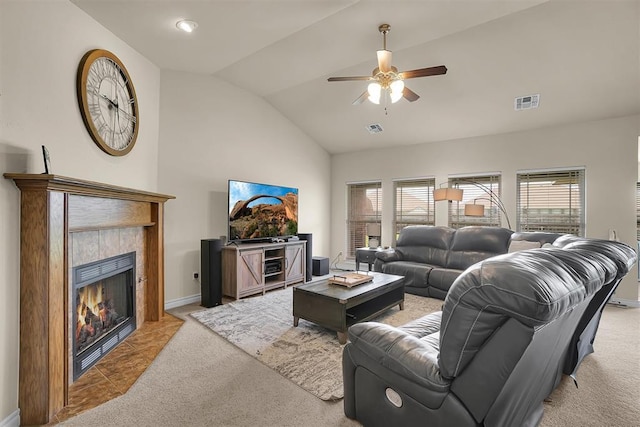 1809 Foxtail Cir, Altus, OK 73521 - living area with light colored carpet, a ceiling fan, vaulted ceiling, a tiled fireplace, and plenty of natural light