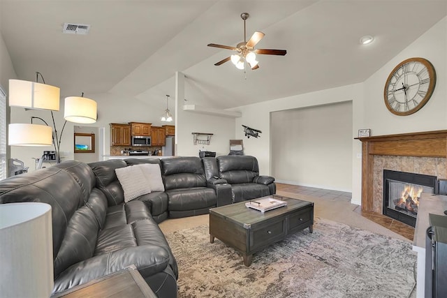 1809 Foxtail Cir, Altus, OK 73521 - living room with lofted ceiling, ceiling fan, a fireplace with flush hearth, and light tile patterned flooring