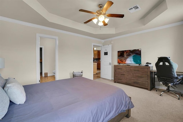 1809 Foxtail Cir, Altus, OK 73521 - bedroom with a tray ceiling, light carpet, ornamental molding, connected bathroom, and a ceiling fan