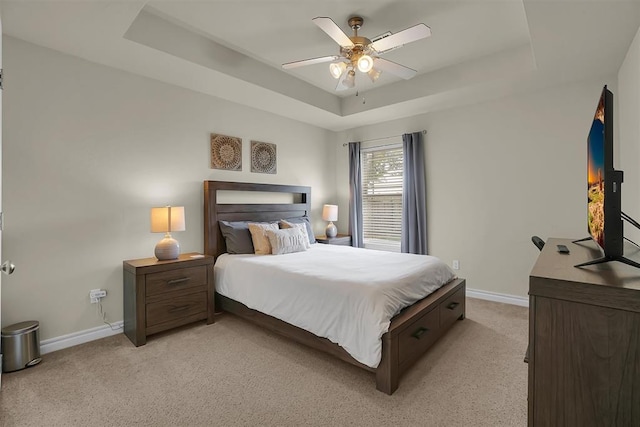 1809 Foxtail Cir, Altus, OK 73521 - bedroom featuring a raised ceiling, light colored carpet, and ceiling fan