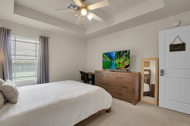 1809 Foxtail Cir, Altus, OK 73521 - bedroom featuring a raised ceiling, light colored carpet, and ceiling fan