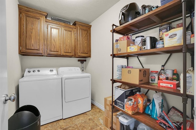 1809 Foxtail Cir, Altus, OK 73521 - laundry area featuring washing machine and clothes dryer, cabinet space, and stone finish flooring