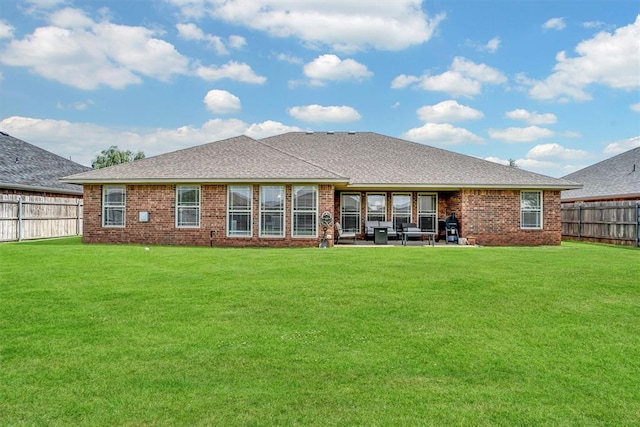 1809 Foxtail Cir, Altus, OK 73521 - rear view of house with a fenced backyard, brick siding, a shingled roof, and a patio