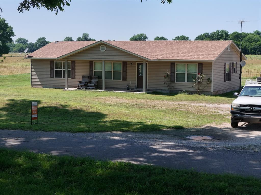 1103 Sooner Rock Rd, Davis, OK 73030 - single story home with a front lawn and roof with shingles