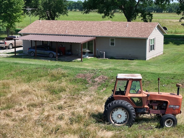 1103 Sooner Rock Rd, Davis, OK 73030 - rear view of property with roof with shingles, a yard, and a carport
