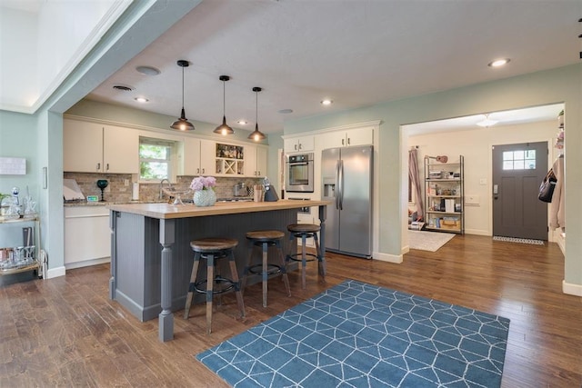434 NW 48th St, Oklahoma City, OK 73118 - kitchen with appliances with stainless steel finishes, dark wood finished floors, healthy amount of natural light, a center island, and recessed lighting