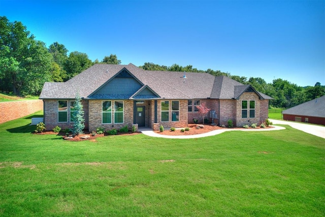 13524 SE 95th St, Oklahoma City, OK 73165 - craftsman inspired home with a front yard, a shingled roof, and brick siding
