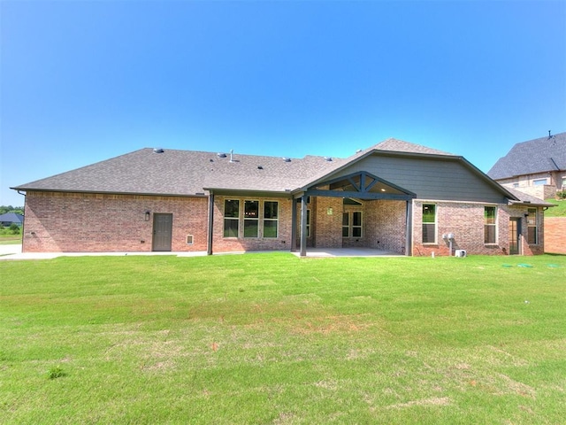 13524 SE 95th St, Oklahoma City, OK 73165 - back of house with a patio, brick siding, and a yard