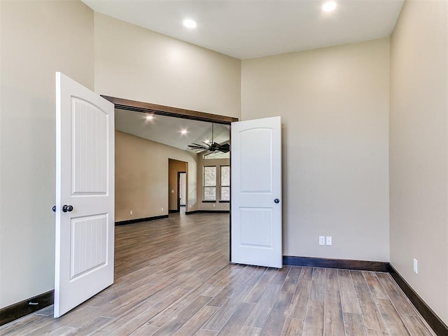 13524 SE 95th St, Oklahoma City, OK 73165 - unfurnished room featuring ceiling fan, wood finished floors, high vaulted ceiling, and recessed lighting