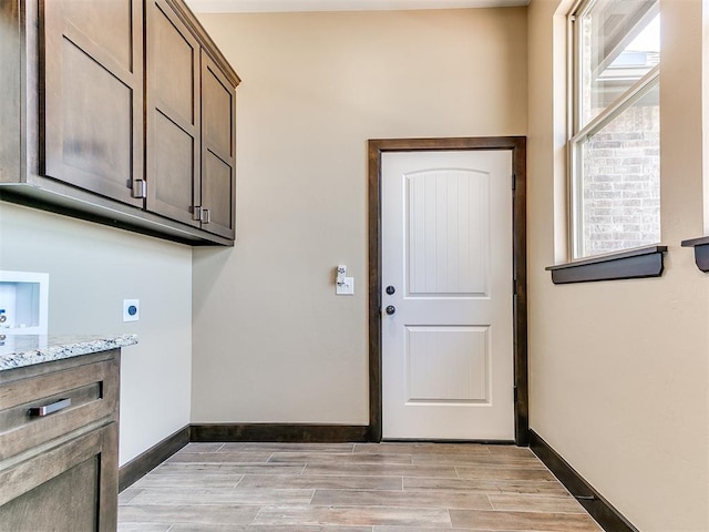 13524 SE 95th St, Oklahoma City, OK 73165 - washroom with hookup for an electric dryer, cabinet space, light wood-style floors, and hookup for a washing machine