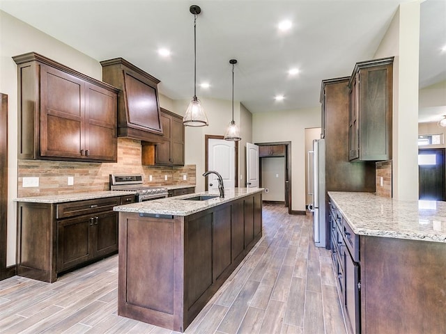 13524 SE 95th St, Oklahoma City, OK 73165 - kitchen featuring stainless steel appliances, dark brown cabinetry, light wood-style floors, and recessed lighting