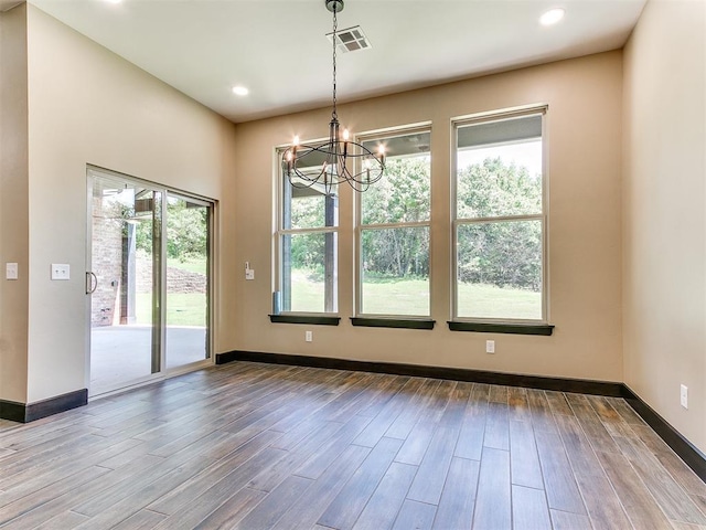 13524 SE 95th St, Oklahoma City, OK 73165 - unfurnished dining area with a chandelier, wood finished floors, and recessed lighting