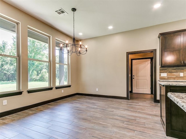 13524 SE 95th St, Oklahoma City, OK 73165 - unfurnished dining area featuring plenty of natural light, a chandelier, light wood-style floors, and recessed lighting