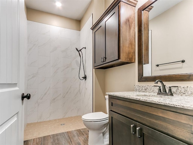13524 SE 95th St, Oklahoma City, OK 73165 - bathroom with vanity, a tile shower, and wood finished floors