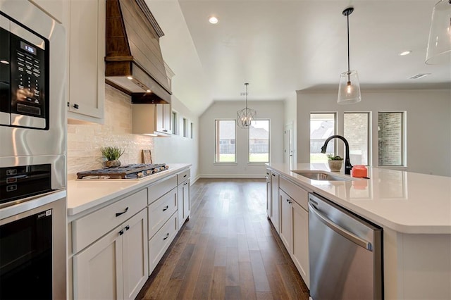 3328 Slate River Dr, Yukon, OK 73099 - kitchen featuring stainless steel appliances, custom exhaust hood, decorative backsplash, light countertops, and dark wood finished floors