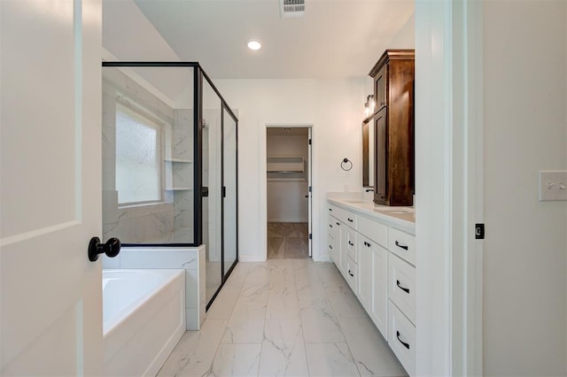 3328 Slate River Dr, Yukon, OK 73099 - bathroom with marble look tiles, a shower stall, a bath, double vanity, and recessed lighting