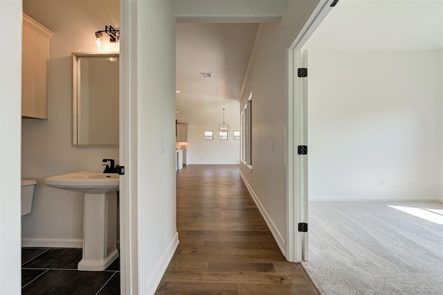 3328 Slate River Dr, Yukon, OK 73099 - hall featuring baseboards and dark wood-style flooring