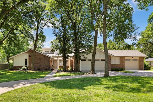 2 Terra Ln, Shawnee, OK 74804 - mid-century home featuring brick siding, a garage, and driveway