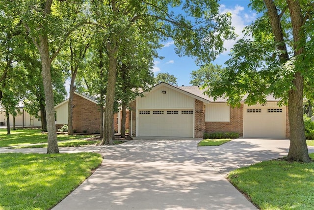 2 Terra Ln, Shawnee, OK 74804 - mid-century modern home with brick siding, driveway, a garage, and a front lawn