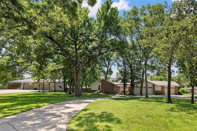 2 Terra Ln, Shawnee, OK 74804 - view of community with a lawn, concrete driveway, and a garage