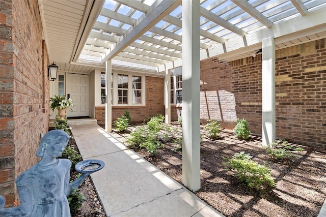 2 Terra Ln, Shawnee, OK 74804 - doorway to property featuring brick siding and a pergola