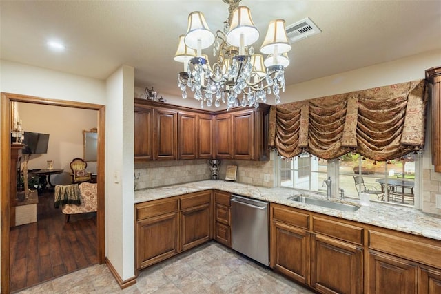 2 Terra Ln, Shawnee, OK 74804 - kitchen with stainless steel dishwasher, decorative backsplash, light stone counters, and a chandelier