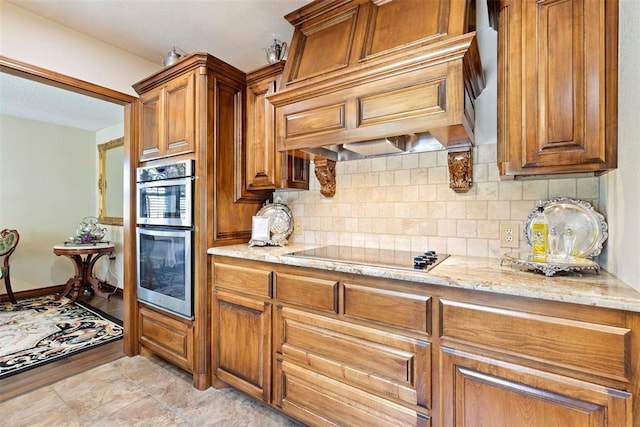 2 Terra Ln, Shawnee, OK 74804 - kitchen with black electric stovetop, stainless steel double oven, brown cabinets, and tasteful backsplash