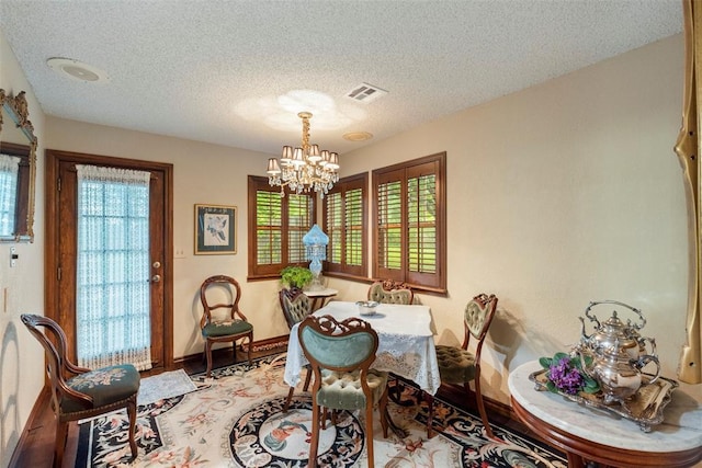 2 Terra Ln, Shawnee, OK 74804 - dining room featuring a chandelier and a textured ceiling