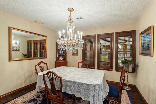 2 Terra Ln, Shawnee, OK 74804 - dining space with wood finished floors, a chandelier, and a textured ceiling
