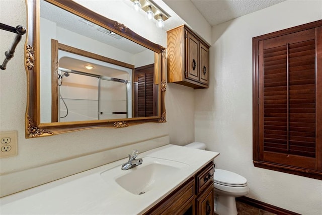 2 Terra Ln, Shawnee, OK 74804 - bathroom featuring vanity, an enclosed shower, and a textured ceiling