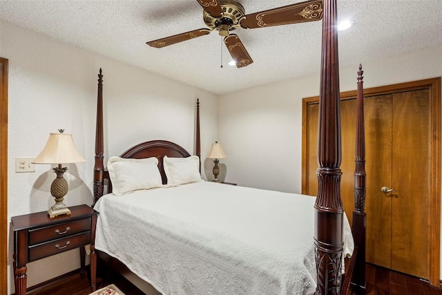 2 Terra Ln, Shawnee, OK 74804 - bedroom featuring dark wood-type flooring, a textured ceiling, and a ceiling fan