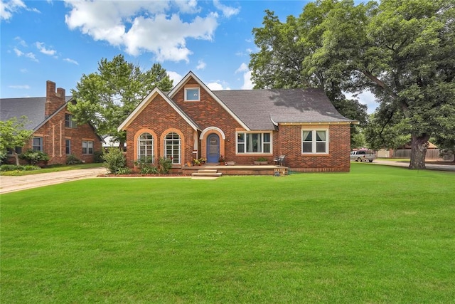 201 S Park Rd, Hobart, OK 73651 - tudor home featuring brick siding and a front yard
