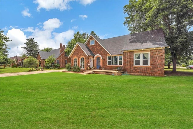 201 S Park Rd, Hobart, OK 73651 - view of front facade with brick siding, a front lawn, roof with shingles, and a chimney