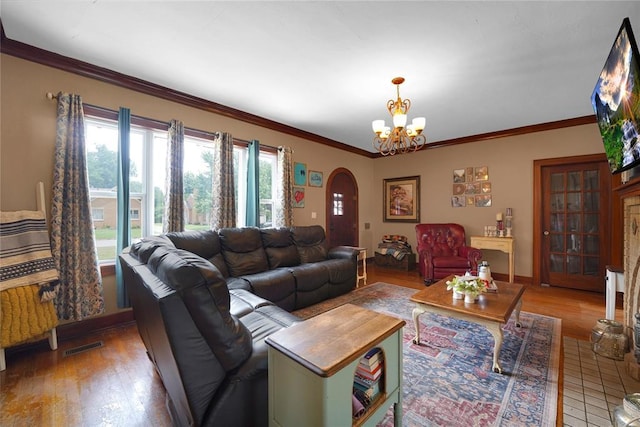 201 S Park Rd, Hobart, OK 73651 - living room with arched walkways, wood finished floors, a chandelier, and crown molding