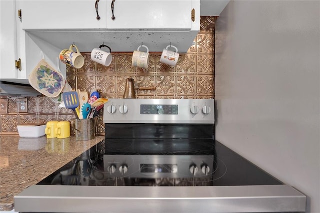 201 S Park Rd, Hobart, OK 73651 - kitchen view of stainless steel electric range oven and tasteful backsplash