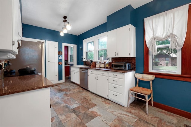 201 S Park Rd, Hobart, OK 73651 - kitchen featuring appliances with stainless steel finishes, white cabinetry, light stone finish floors, dark stone countertops, and tasteful backsplash