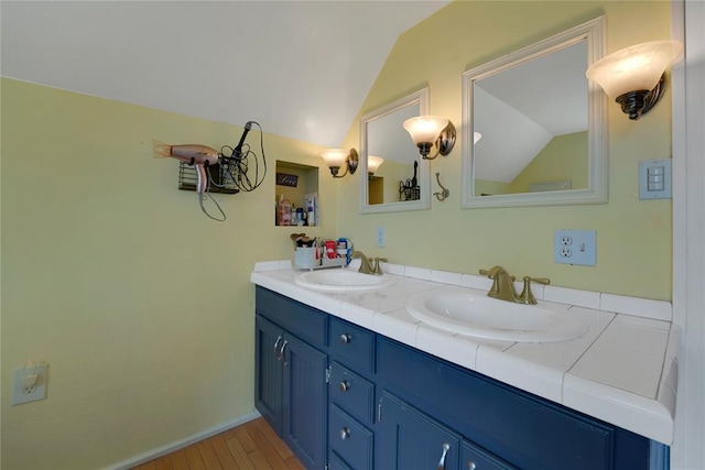 201 S Park Rd, Hobart, OK 73651 - full bathroom featuring vaulted ceiling, double vanity, and wood finished floors