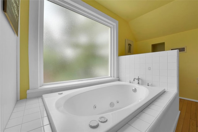201 S Park Rd, Hobart, OK 73651 - bathroom featuring vaulted ceiling, a tub with jets, and wood finished floors