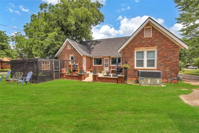 201 S Park Rd, Hobart, OK 73651 - back of property featuring brick siding, a lawn, a shingled roof, and a patio area