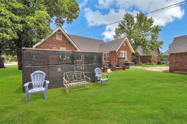 201 S Park Rd, Hobart, OK 73651 - back of house with brick siding, a lawn, and roof with shingles