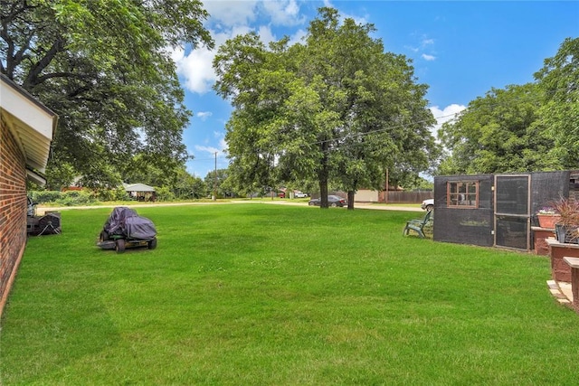 201 S Park Rd, Hobart, OK 73651 - view of green lawn featuring exterior structure and an outdoor structure