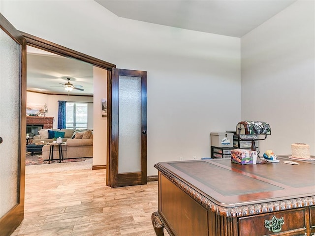 13512 SE 95th St, Oklahoma City, OK 73165 - office space featuring light wood-style floors, ceiling fan, and a brick fireplace